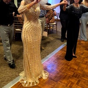 Nude bejeweled long sleeved gown